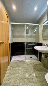 a bathroom with a shower and a sink at Pensión Laforja in Barcelona