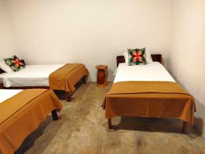 a room with two beds in a room at Primer Canto B&B - Near Ferry & Early Birdwatching Trails in Lepanto