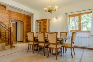 a dining room with a wooden table and chairs at Casa en Bosque de Pinos in San Carlos de Bariloche +46 photos