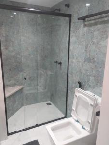 a bathroom with a shower with a toilet and a sink at Eco Paradise 227 in Cumbuco +9 photos