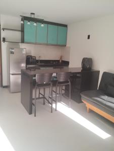 a kitchen with a table and chairs and a couch at Eco Paradise 227 in Cumbuco