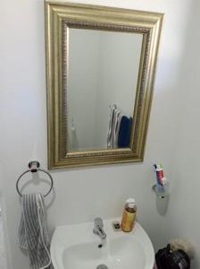 a bathroom with a white sink and a mirror at Bee Bee Adventures in Ballito +20 photos