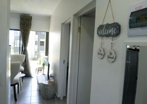 a living room with a sign on the wall at Bee Bee Adventures in Ballito