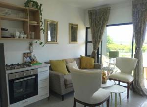 a living room with a couch and a stove at Bee Bee Adventures in Ballito