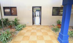 an empty hallway with a blue pillar and plants at Suite Esteli 114 Gran Pacifica Resort in San Diego