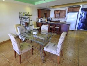 a dining room with a glass table and chairs at Suite Esteli 114 Gran Pacifica Resort in San Diego