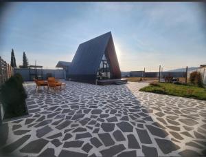 a building with chairs and tables on a stone patio at Day Off in Dushetʼi +26 photos