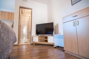 a living room with a television and a dresser at Biser Kupresa 2 in Kupres