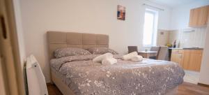 a bedroom with a bed with two towels on it at Biser Kupresa 2 in Kupres