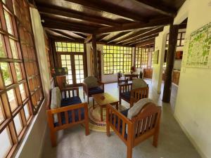 a room with chairs and tables and windows at Yawira House in Leticia