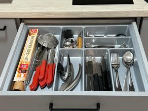 a drawer filled with utensils in a cabinet at Apartment Sebald in Ingolstadt