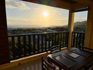a balcony with a table and a view of the ocean at Apartment with exceptional views, Saint-Joseph in Saint-Joseph