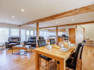 a dining room and living room with a table and chairs at 1 Bed in Faringdon 88573 in Coxwell