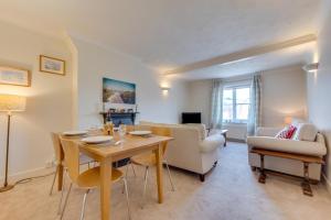 a living room with a wooden table and chairs at 3 Bed in Woodbridge oc-tst in Melton