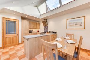 a kitchen and dining room with a table and a window at 2 Bed in Southwold oc-weh in Southwold