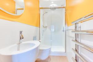 a bathroom with a shower and a sink and a toilet at 2 Bed in Southwold oc-weh in Southwold +3 photos