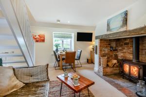 a living room with a couch and a fireplace at 2 Bed in Heacham oc-2013 in Heacham