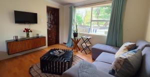 a living room with a couch and a tv at Moya Guesthouse in Johannesburg +15 photos
