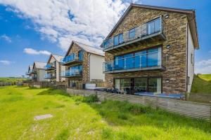 an exterior view of a house with large windows at 6 Bed in Winnards Perch oc-t29966 in Saint Columb Major
