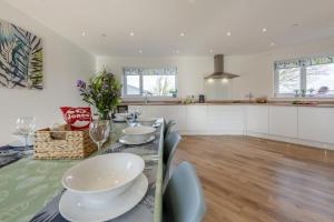 a kitchen with a table with dishes on it at 4 Bed in Aberarth oc-g30835 in Aberaeron