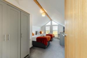 a bedroom with two beds and a window at 4 Bed in Aberarth oc-g30835 in Aberaeron