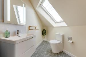 a bathroom with a sink and a toilet with skylights at 4 Bed in Aberarth oc-g30835 in Aberaeron +33 photos