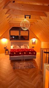 a bedroom with a large bed in a wooden room at Jeleśniczówka in Jeleśnia