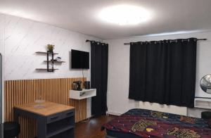 a bedroom with a bed and a television in a room at Midnight Crown Suite in Hannover