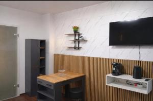 a living room with a television on a wall at Midnight Crown Suite in Hannover