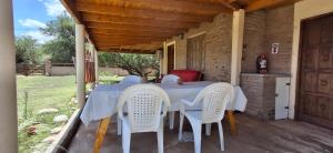 a table and chairs on the porch of a house at Cabaña Rincón de Afrodita in San Lorenzo
