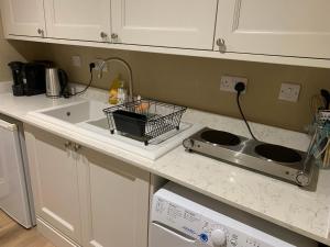 a kitchen counter with a sink and a dishwasher at The Somerton Hideaway in Somerton