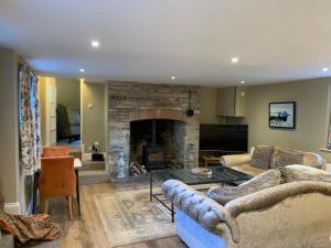 a living room with two couches and a fireplace at The Somerton Hideaway in Somerton