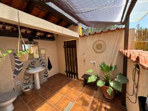 an outdoor bathroom with a toilet and a sink at Quinta Ivonne in Montemor-o-Velho