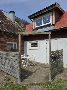 a patio with a table and a house at Apartment Norrgården in Genevad