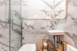 a bathroom with a shower and a toilet and a sink at Carregado First Floor in Carregado +33 photos