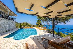 an outdoor pool with a view of the ocean at Villa Nefeli in Apergátika