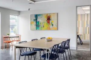 a table with chairs and a painting on the wall at Cincinnati Downtown Oasis in Cincinnati