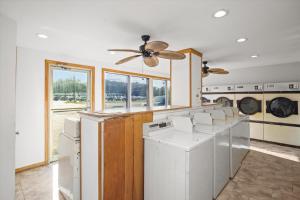 a laundry room with washing machines and a ceiling fan at Angelina Motel in Lufkin