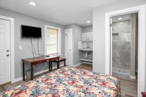 a bedroom with a bed with a desk and a tv at Angelina Motel in Lufkin