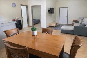 a living room with a table and a couch at Samoa Business Apartments 2 in Apia