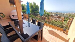 a table and chairs on a balcony with a view at Luna-Villa de Riviera with Sea-View in Mijas Costa +21 photos