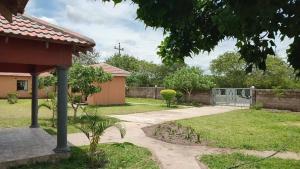 a house with a gate in the yard at Cozy Road Lodge in Sihangwane