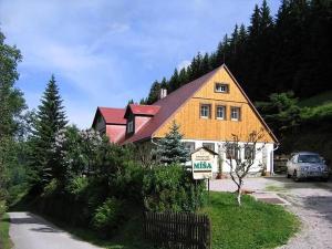 a large house with a car parked in front of it at Rodinný penzion Míša in Velká Úpa