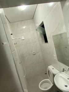 a bathroom with a shower and a toilet and a sink at Fênix 2 in São Paulo