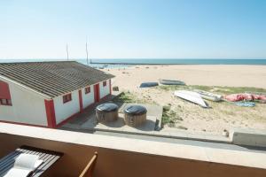 a view of a beach with a building and two trash cans at House In Aguda Beach, praia da Aguda, in Aguda