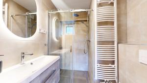 a bathroom with a sink and a shower at Villa Montis in Deštné v Orlických horách +22 photos