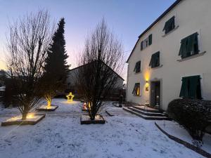 a snow covered yard with a building and a fire hydrant at Saar-Lor-Lux-Perle in Merzig