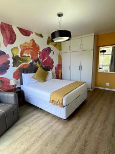 a bedroom with a large white bed and a couch at Oceanic 2 Bedroom Apartment - Ocean and Park View - Self-Catering in Durban +33 photos