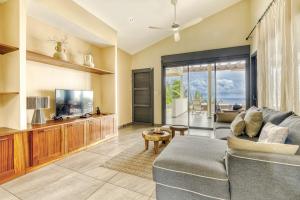 a living room with a couch and a tv at Comme un bateau sur l'océan in Saint-Leu