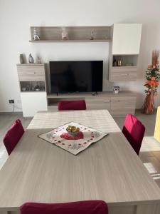 a living room with a table with a plate on it at Pino s house in Inveruno